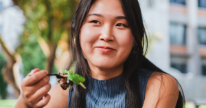 Smiling college student eating salad 1200x627