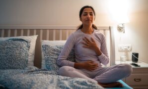 Indian Female Practicing Relaxation Before Sleep in Bedroom 2184439853 1257x838