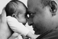 father looking at baby