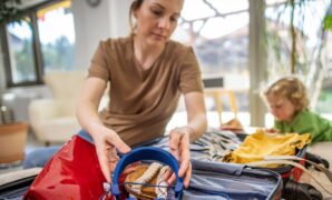 mother son packing suitcase