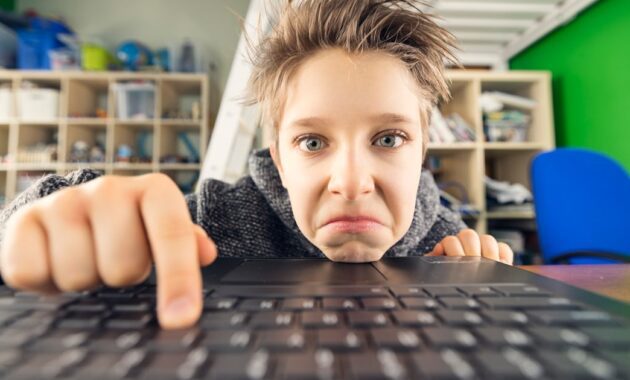 teenage boy using laptop