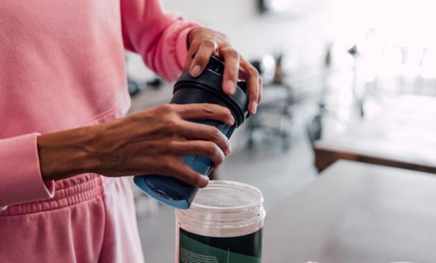 woman preparing protein shake