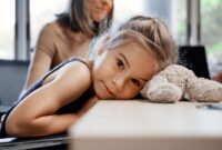 little girl rests head.jpg