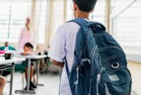 student carrying backpack arriving.jpg