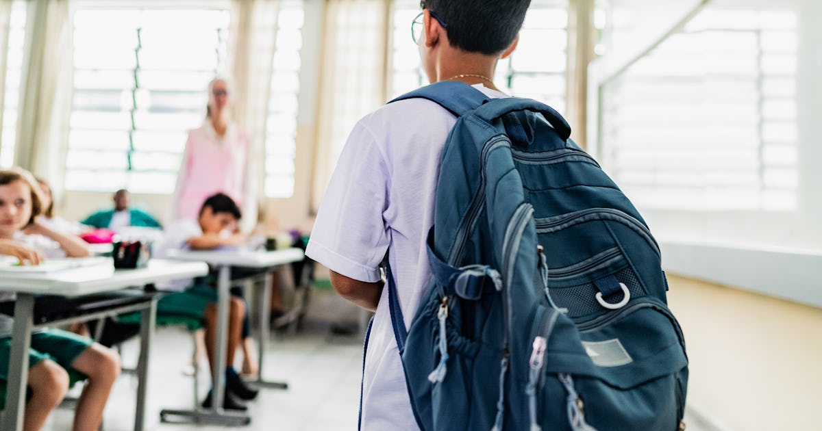 student carrying backpack arriving.jpg