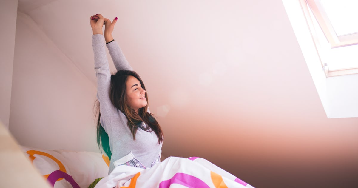 woman stretching in bed