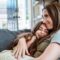 Young girl and mother hug each other on the couch 1891412676 1258x838.jpeg