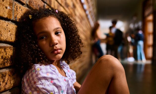schoolgirl sitting on floor.jpg