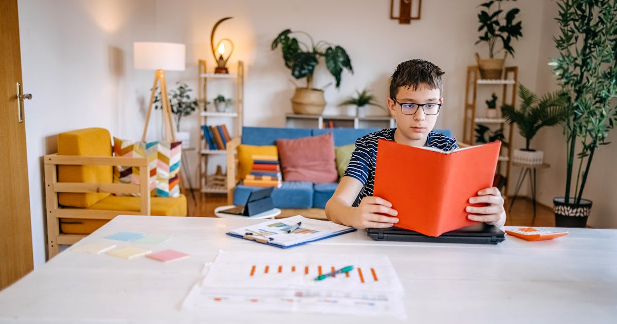 teenager holding book in.jpg