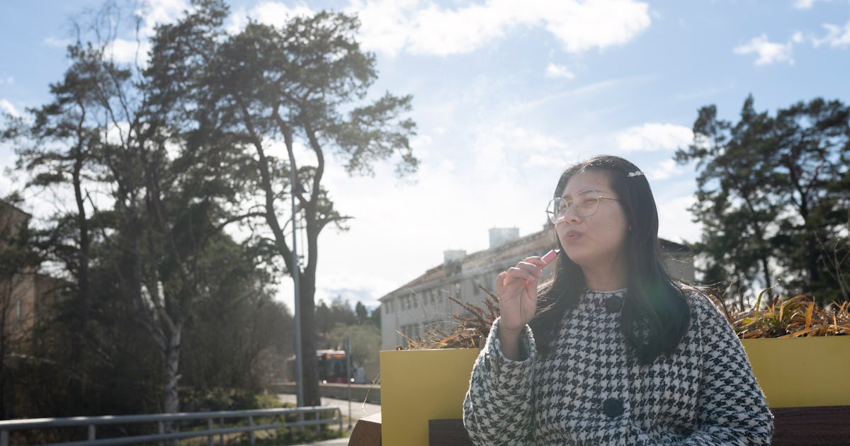 woman smoking vape pen.jpg