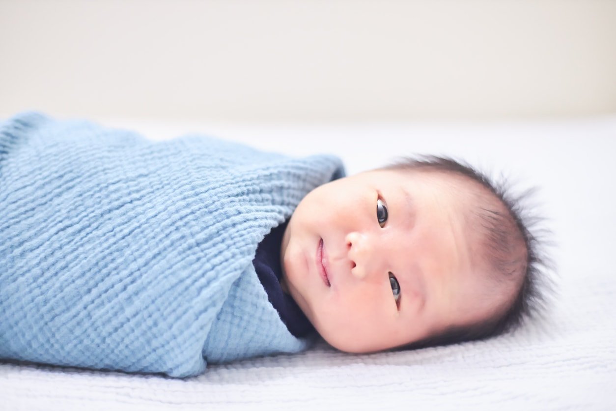Child is laying in bed with smiling face 1347048597 1258x838.jpeg