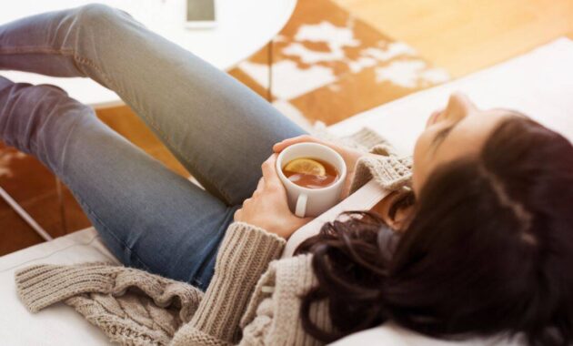 relaxing at home tea lemon woman couch relaxation mindfulness meditation.jpg