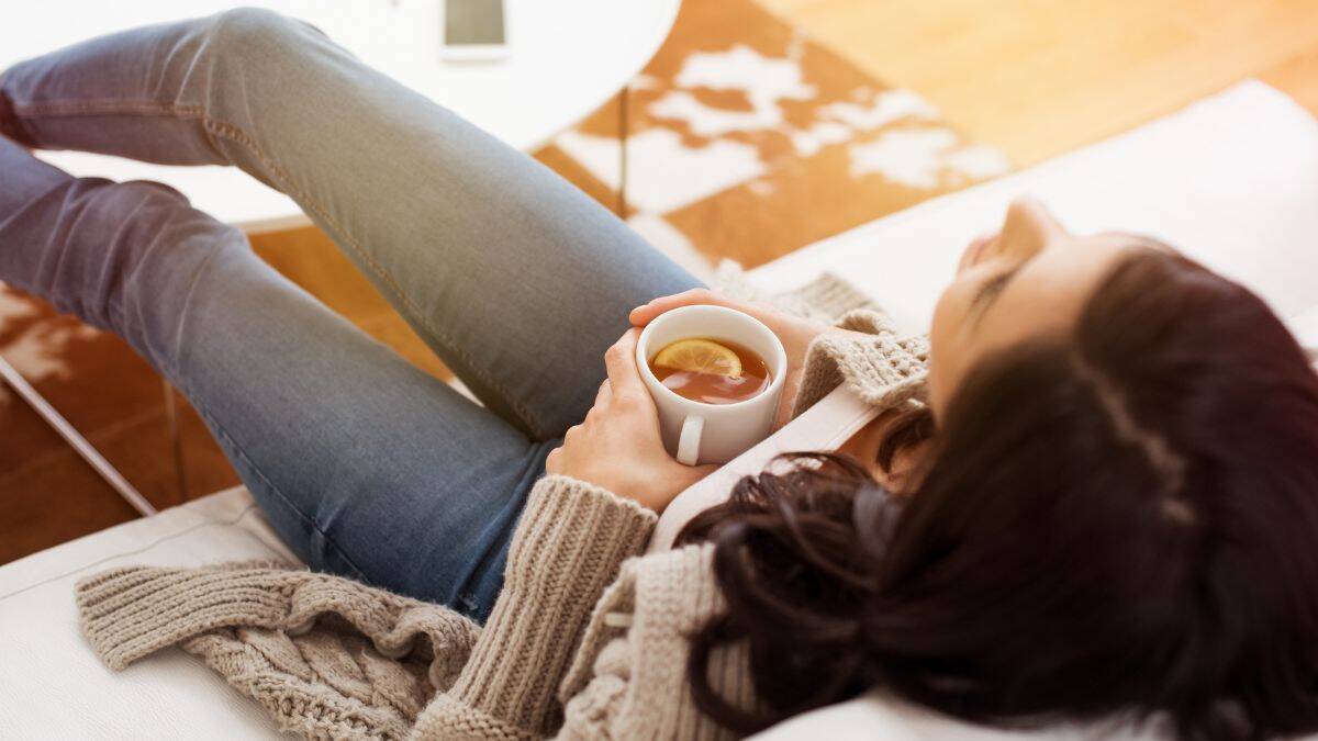 relaxing at home tea lemon woman couch relaxation mindfulness meditation.jpg