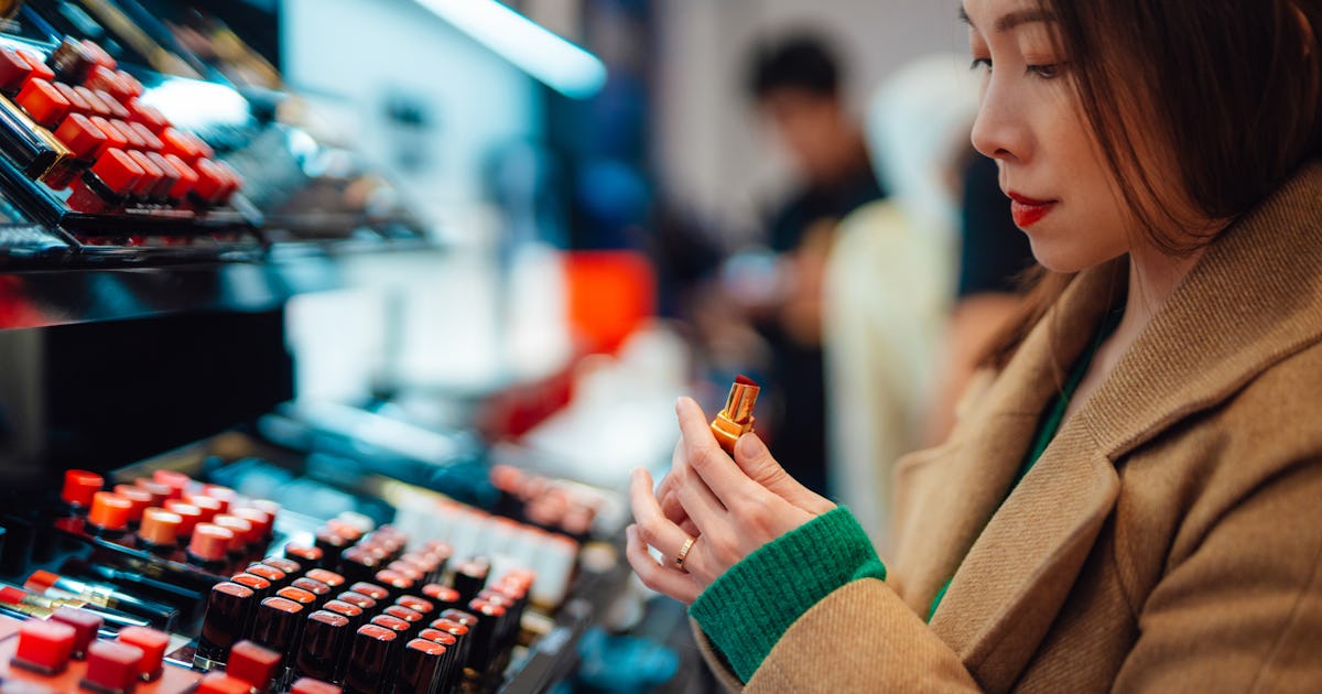 young woman trying lipstick.jpg