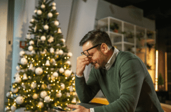 man experiencing seasonal affective disorder by christmas tree.png